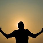 Man with outstretched arms.