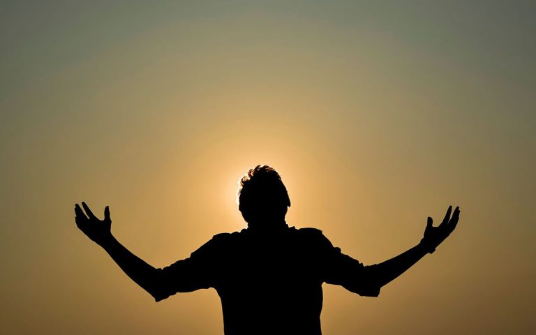 Man with outstretched arms.